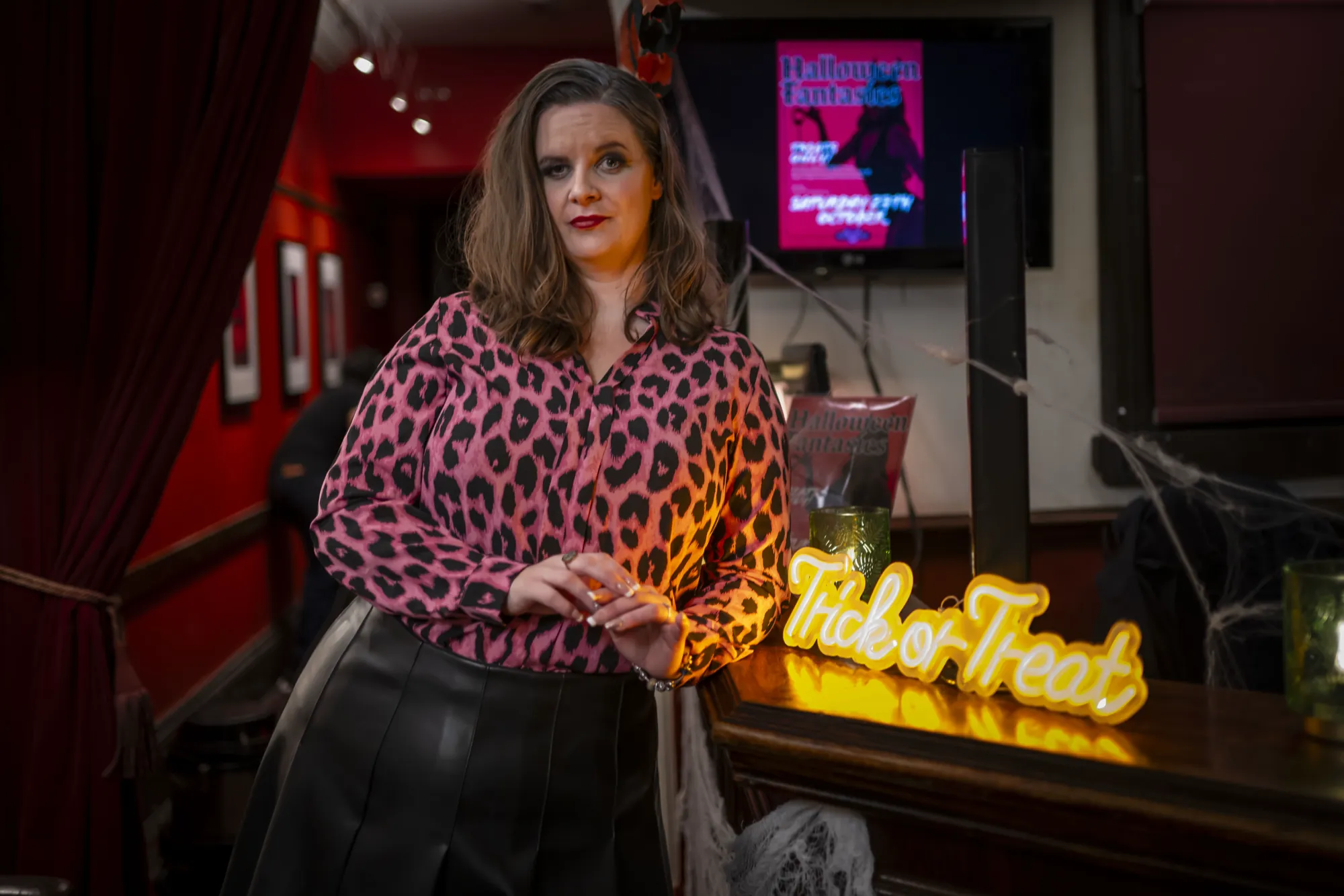 Sharon, the club&rsquo;s boss, at the bar beside a Trick or Treat sign